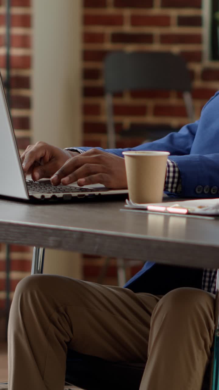 Man working in office with laptop and coffee