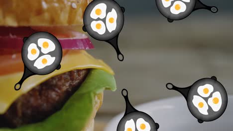 animation of falling pans with fried eggs over burger