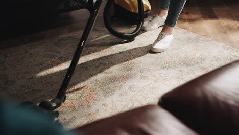 woman is vacuum cleaning at home on a sunday, domestic household maintenance concept