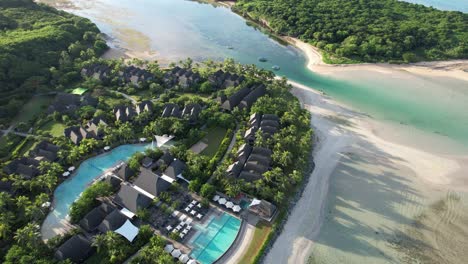 aerial rotation revealing beachfront resort and pools at natadola beach, fiji
