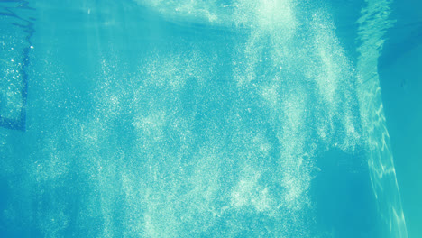 Man-diving-into-blue-swimming-pool