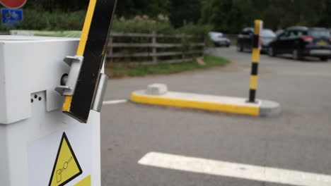 car vehicle barrier gate closing at an entrance access to car park parking lot