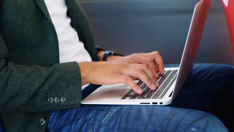 Male-commuter-using-laptop-while-travelling-in-bus-4k