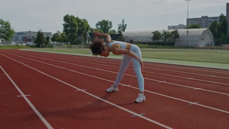 woman stretching on a track