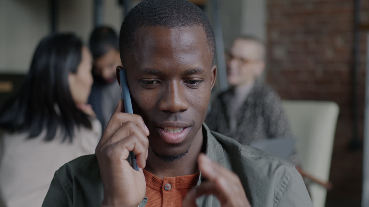 Man in Office Talking on Phone