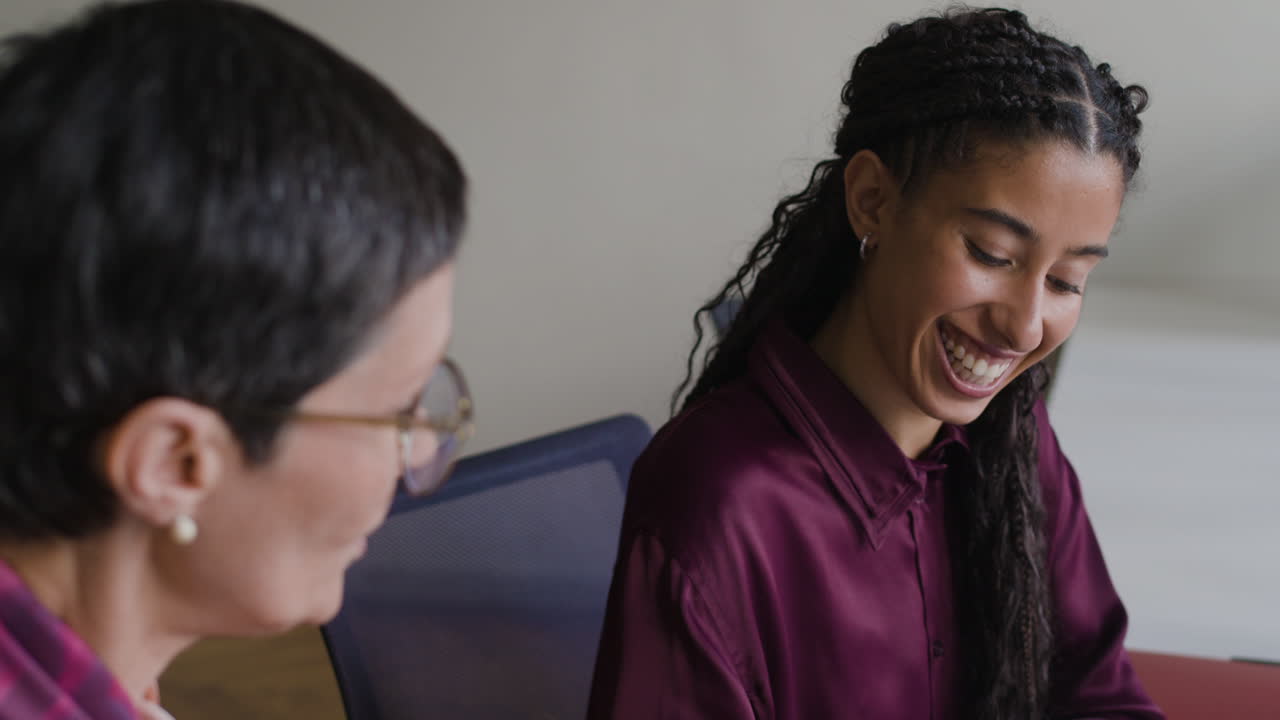 Two Businesswomen Collaborating and Discussing in an Office Meeting