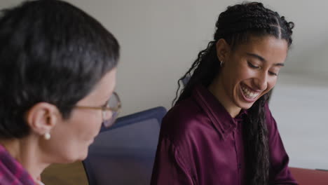 two businesswomen collaborating and discussing in an office meeting
