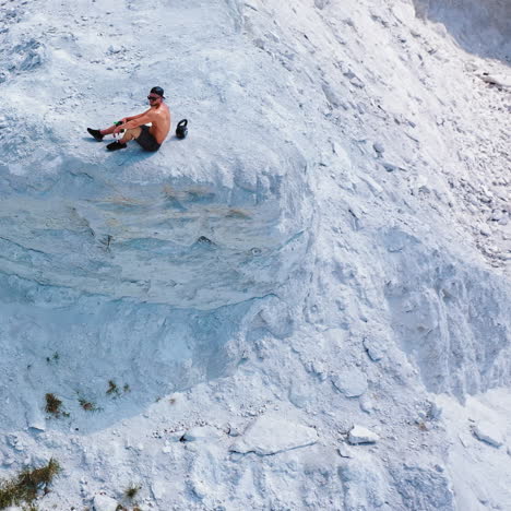 healthy male resting and drinking water after exercising. aerial view