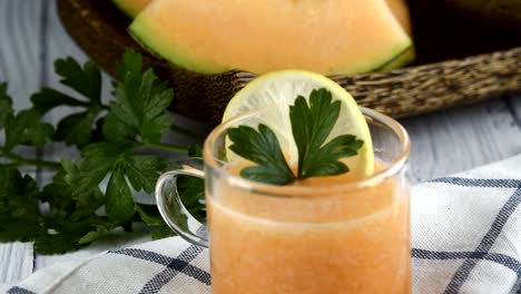 whole and sliced of japanese melons,honey melon or cantaloupe (cucumis melo) glass of melon smoothie healthcare concept.