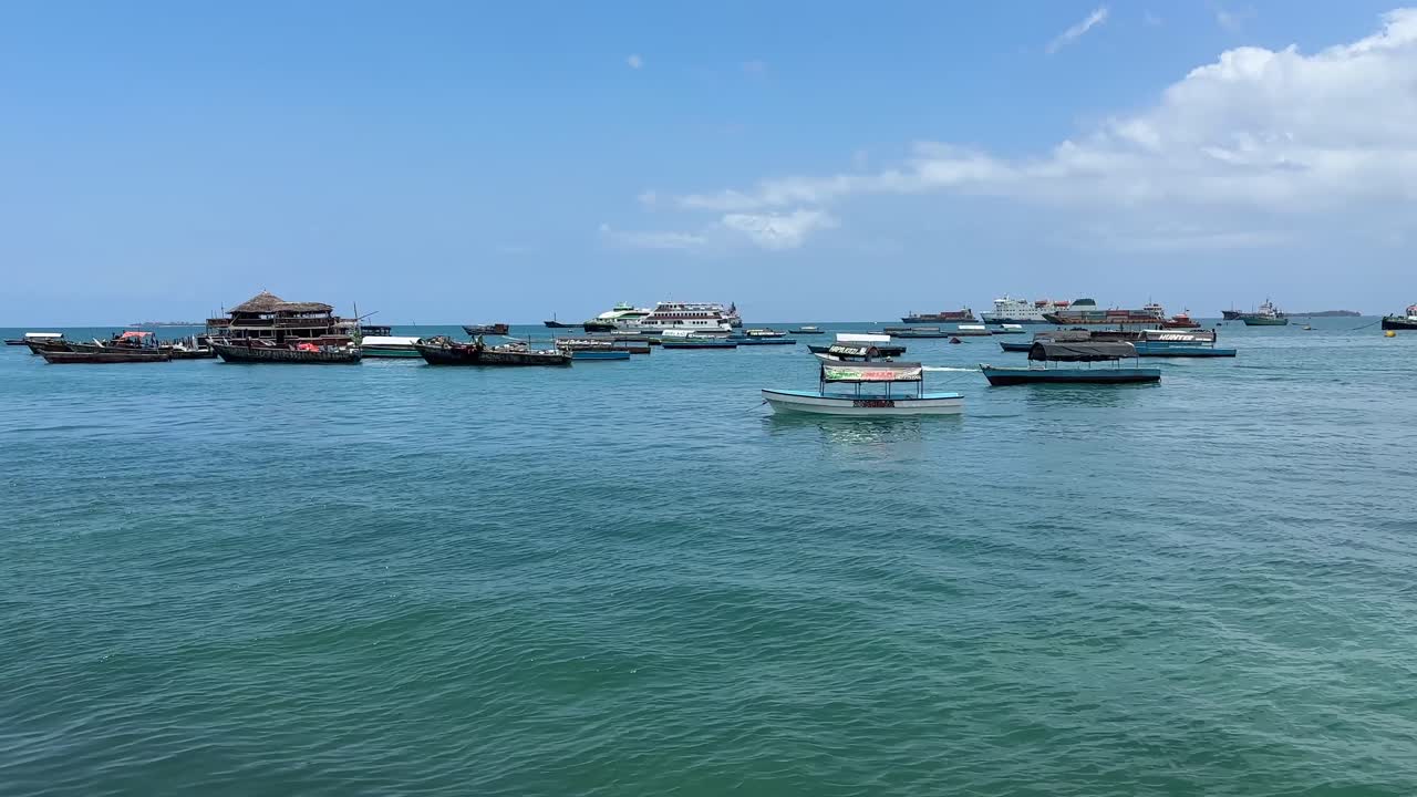 Boats ships at the harbour port in stone town zanzibar city tanzania
