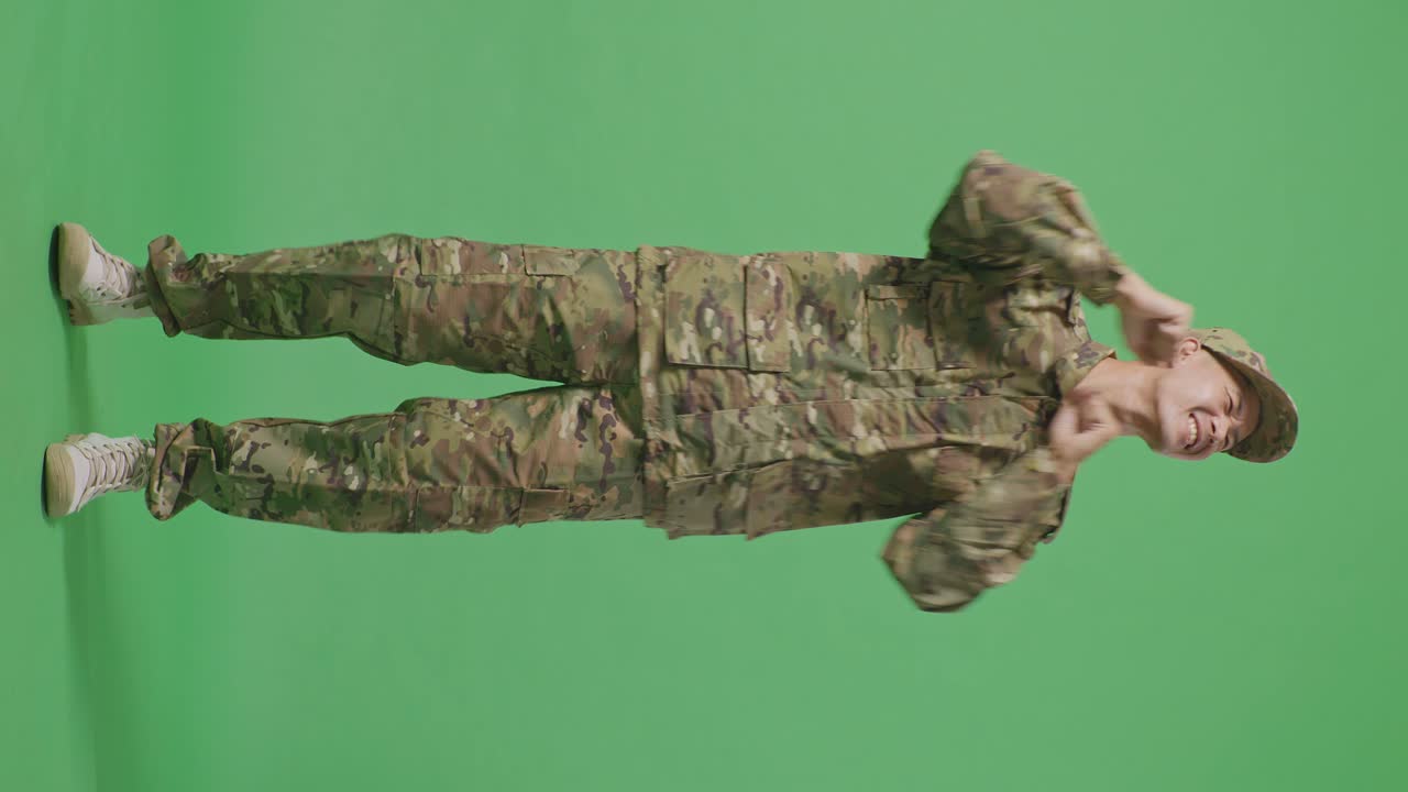 Full Body Of Asian Man Soldier Dancing While Standing In The Green Screen Background Studio