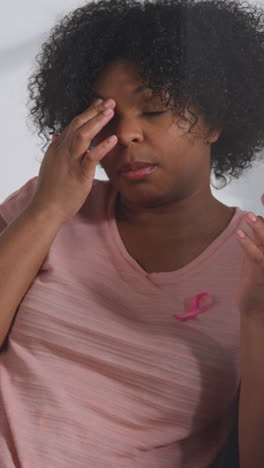 Vertical-Video-Of-Mid-Adult-Woman-Wearing-Pink-Breast-Cancer-Awareness-Ribbon-Meeting-And-Talking-At-Therapy-Support-Group-For-Cancer-Treatment-Patients-With-Counsellor-1