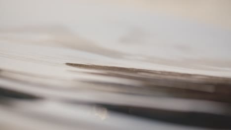 ultra close shot of black strokes getting painted on white paper