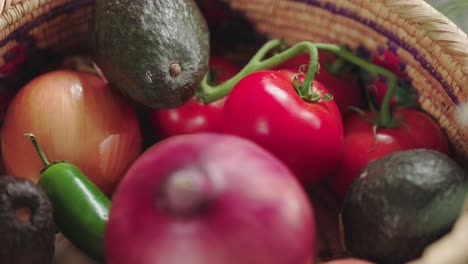 a vibrant basket filled with fresh vegetables like tomatoes, avocados, onions, and jalapeños, perfect for cooking and healthy eating