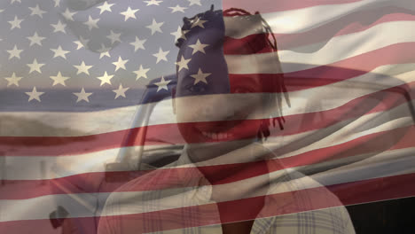 African-American-man-smiling-with-US-flag-waving-foreground