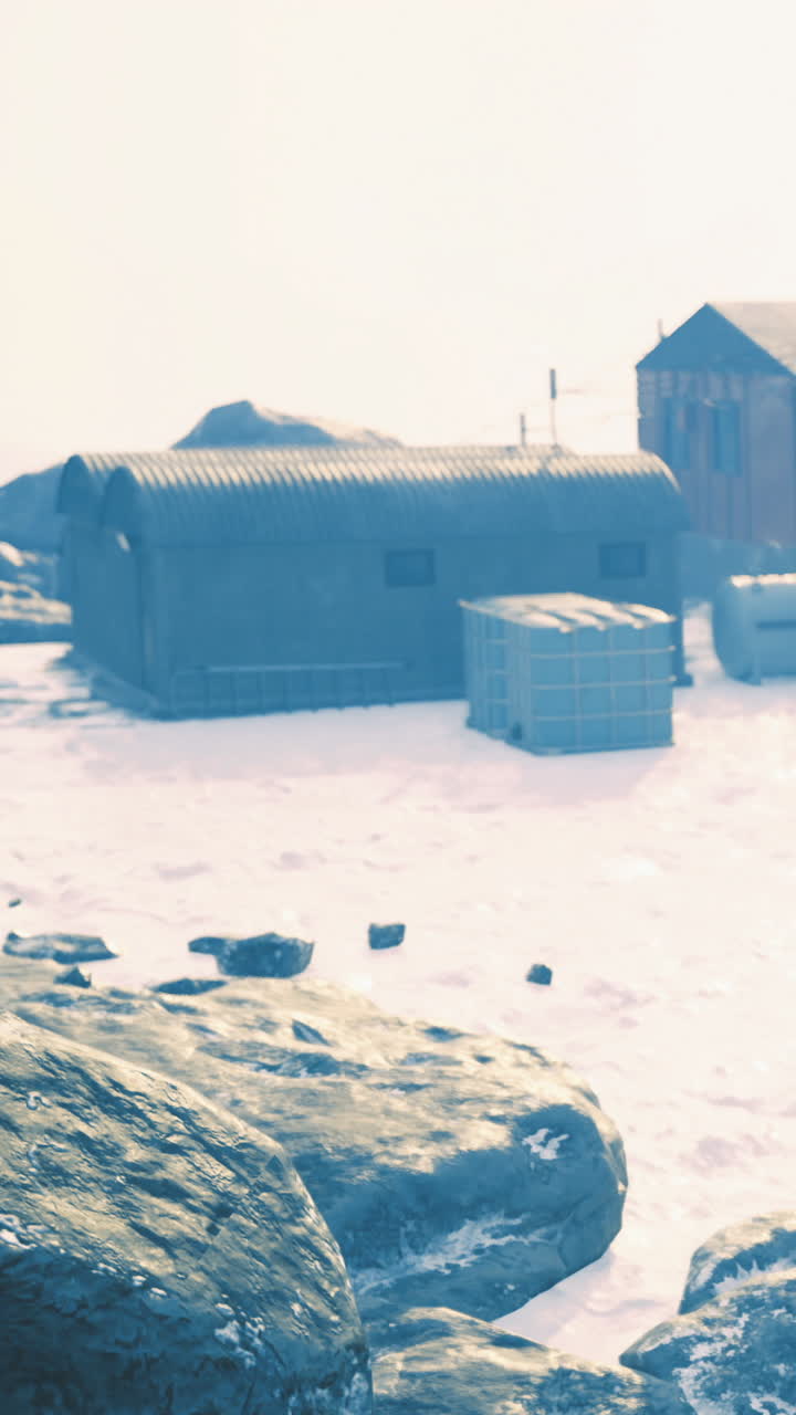 Winter landscape with rustic buildings surrounded by ice and snow