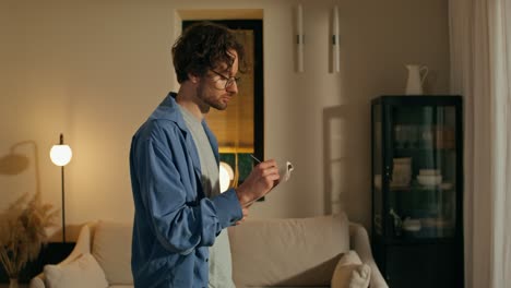 man writing in notebook at home