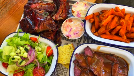 beef brisket with salad, pork ribs with sweet potato fries, cornbread and coleslaw, traditional american food, 4k shot