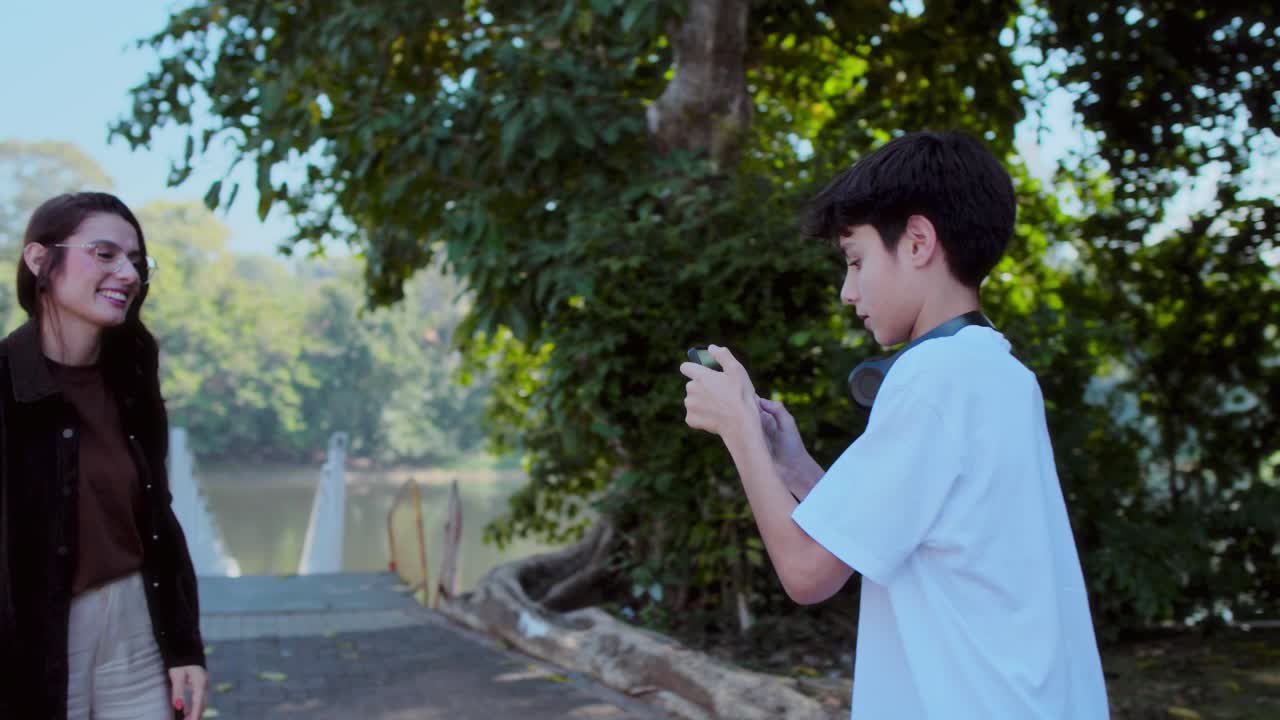 Young People Using Smartphones and Taking Photos in a Park