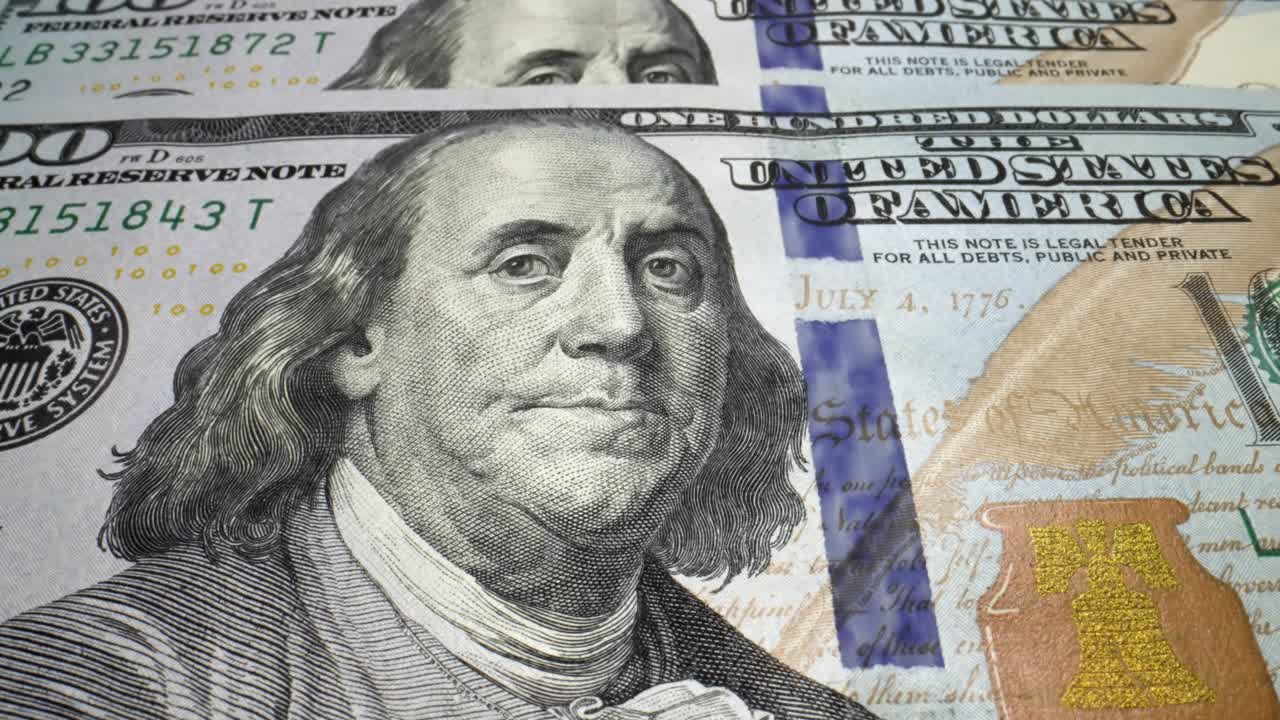 los billetes de 100 dólares estadounidenses están siendo impresos por una máquina de prensa de moneda.