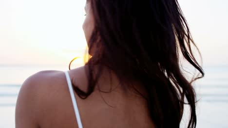 portrait of ethnic girl taking selfie on beach