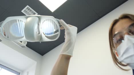 dentist adjusting exam light