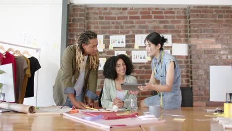 portrait of diverse designers having creative meeting in fashion design studio in slow motion