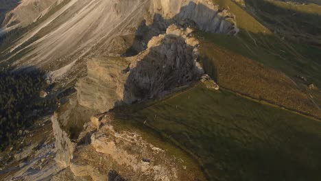 aerial reveal shot of a top of a mountain in dolomites zone italy in a sunny morning
