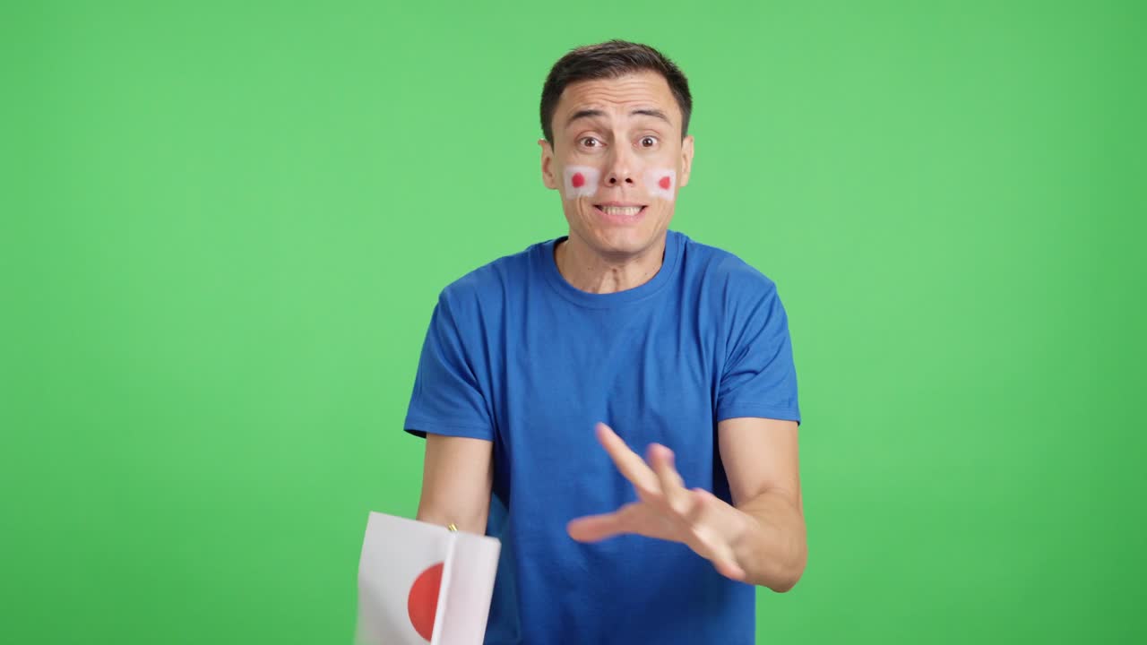 Man cheering for Japan during a match that is lost
