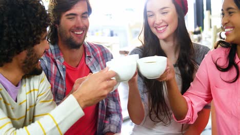 Group-of-friends-toasting-cup-of-coffee