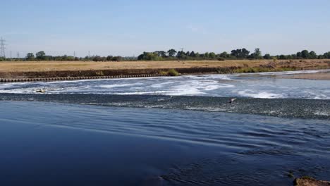 water going over the river trent weir by ratcliffe on soar power station. wide shot