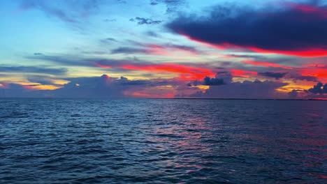 red and crimson colors of the sky over the ocean and clouds in florida keys, usa