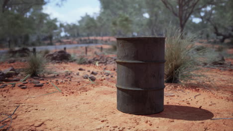 old-empty-rusted-barrel-on-sand