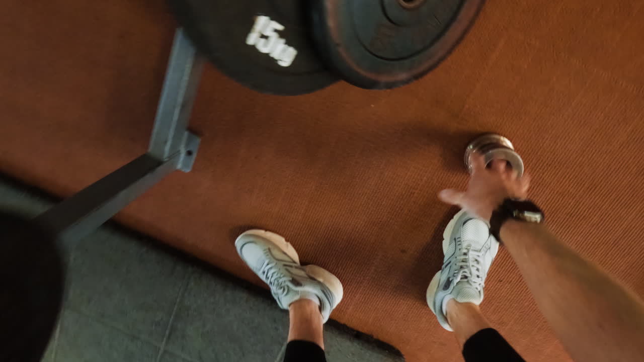 First-Person View of a Person Exercising with Weights in a Gym