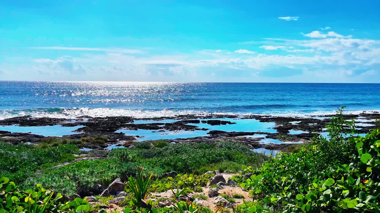 Small waves on a rocky beach in Tulum near Cancun Mexico