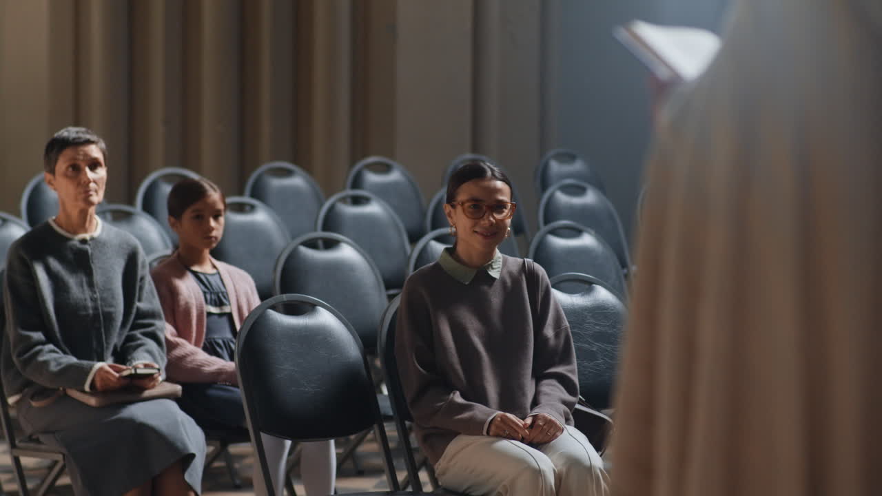 Priest Addressing Congregation in Church