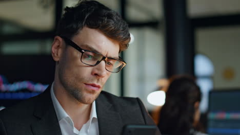 thoughtful businessman working late closeup. successful stock trader analysing