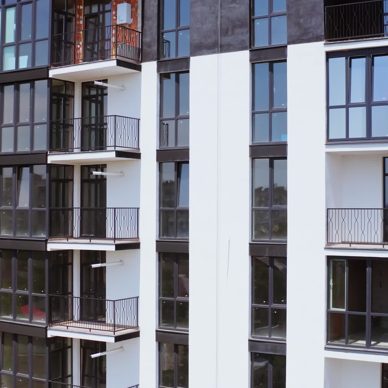 Drone view of apartment buildings. Aerial view of the facade of new residential complex in minimalist style