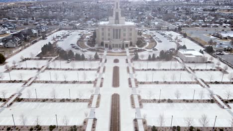 empty parking lot in front of payson utah temple, church of jesus christ of latter-day saints with snowy mountain at wintertime in payson, utah, usa