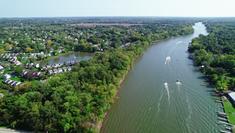 rising-aerial-of-Fox-River-lake-from-Crystal-Lake-Illinois-with-speed-boat-cruising