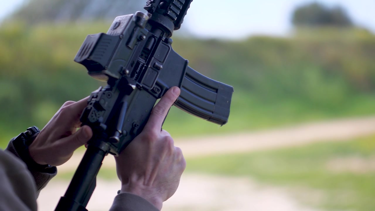 Israeli army soldier prepares rifle by adjusting mechanism during training