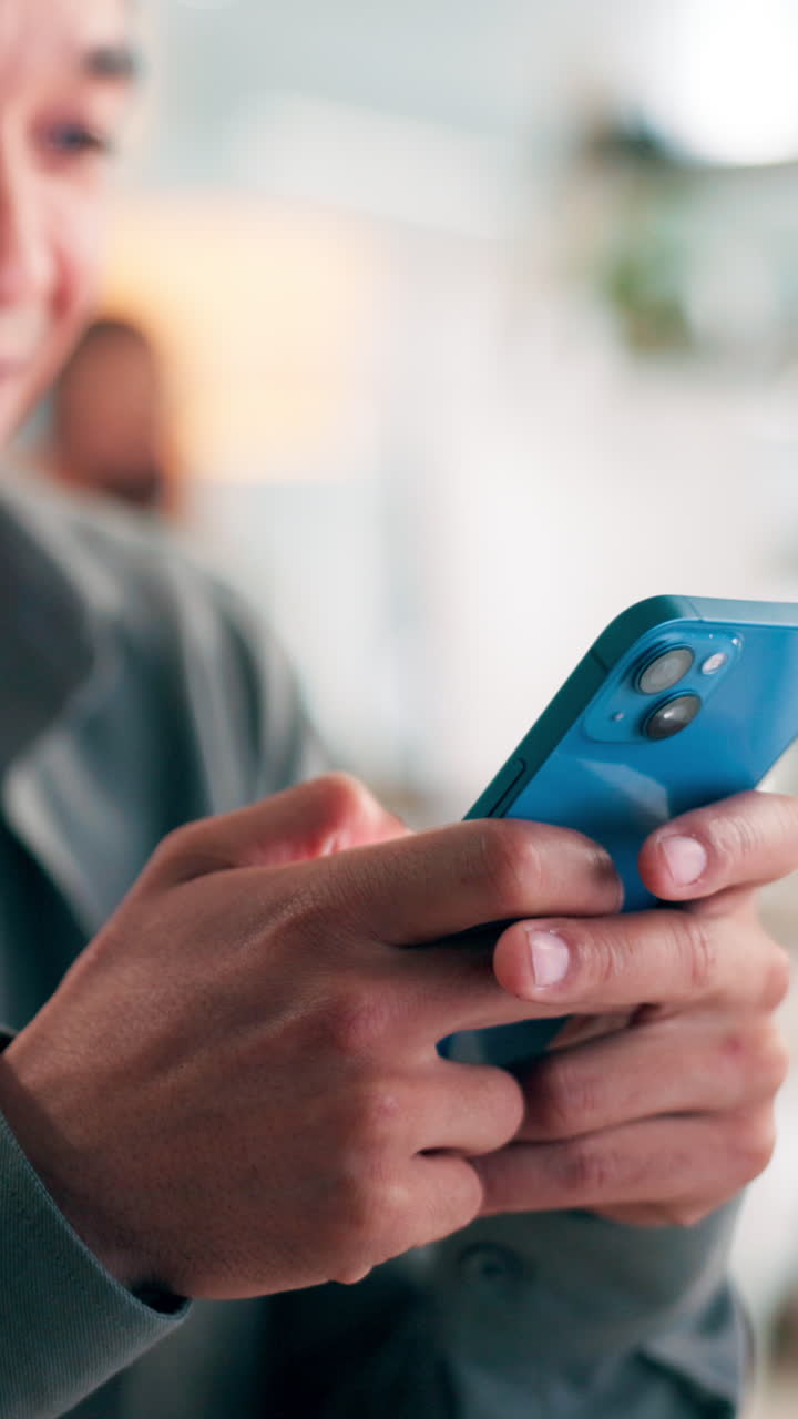 Close-up of Person's Hands Typing on a Blue Smartphone