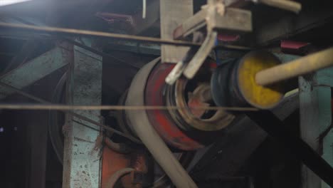 close-up of industrial machinery with moving belts and pulleys