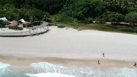 Beautiful-beach-with-clear-warm-turquoise-water-of-the-Caribbean-and-a-calm-spring-fed-fresh-water-river-in-Los-Patos,-Dominican-Republic