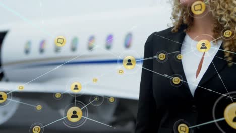 Animation-of-network-of-connections-with-icons-over-biracial-businesswoman-using-smartphone