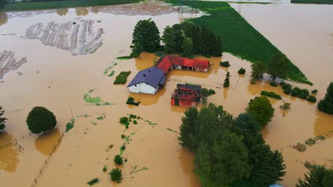 Horrific-Aerial-4K-Drone-footage-of-houses-in-Podravje,-Slovenia,-during-August-floods