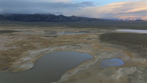 mammoth lakes convict canyon minarets sierra nevada mountains hilltop wild willy's hot springs california aerial drone winter vibrant sunset clouds benton crossing long valley caldera circle right