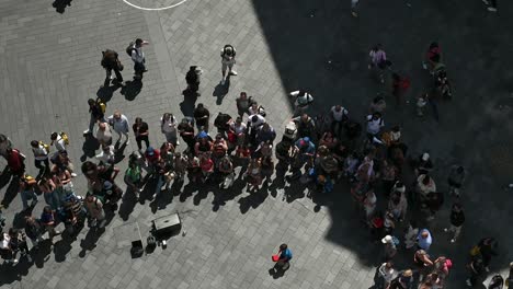 overhead view of a large crowd gathered in a bustling city square