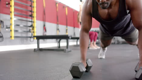 Fit-African-American-man-lifting-weights-at-the-gym