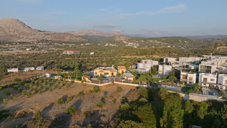 Aerial view of holiday villas on top of a hill, sunny morning in Rhodes, Greece